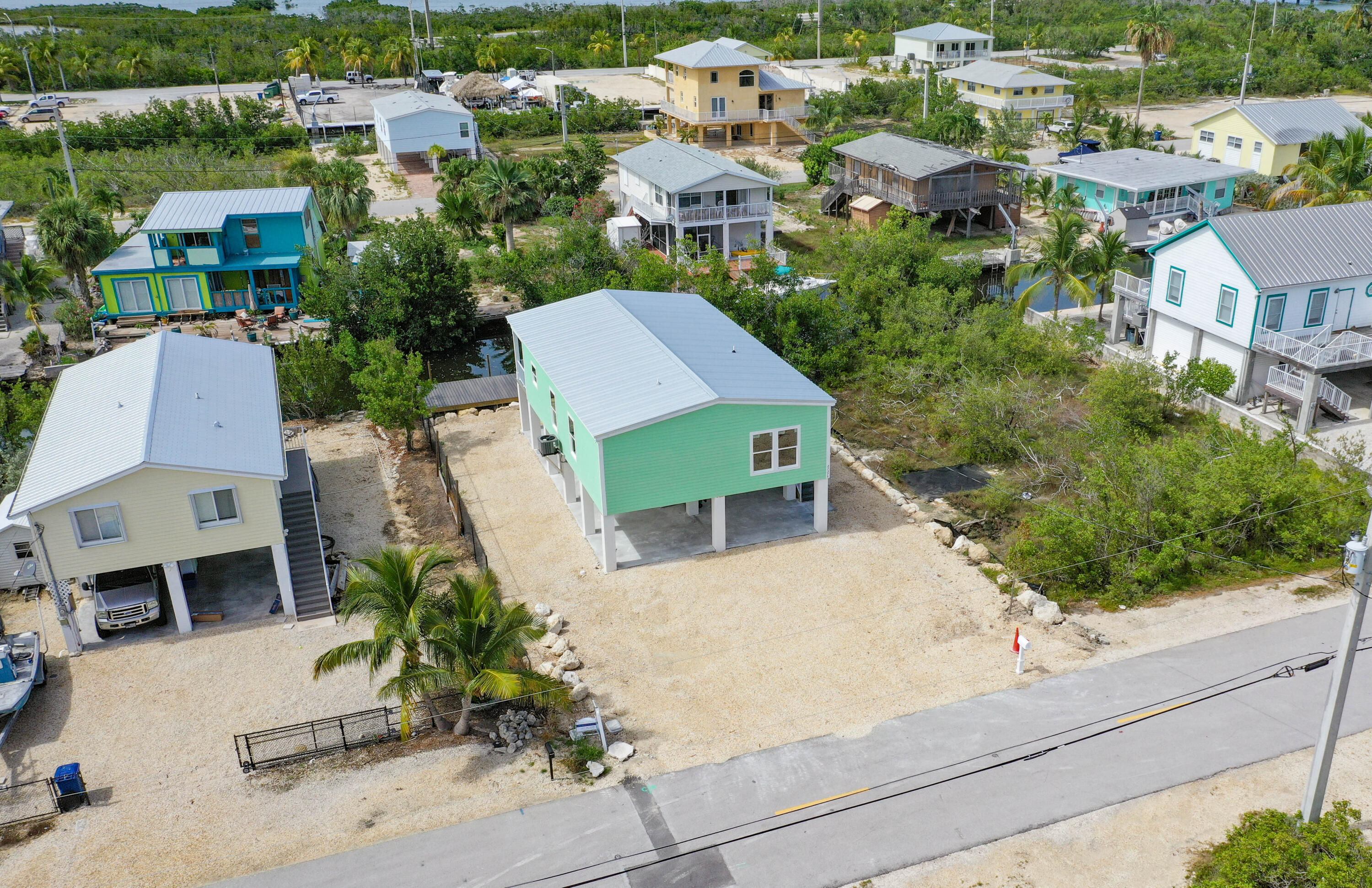 an aerial view of multiple houses with a yard