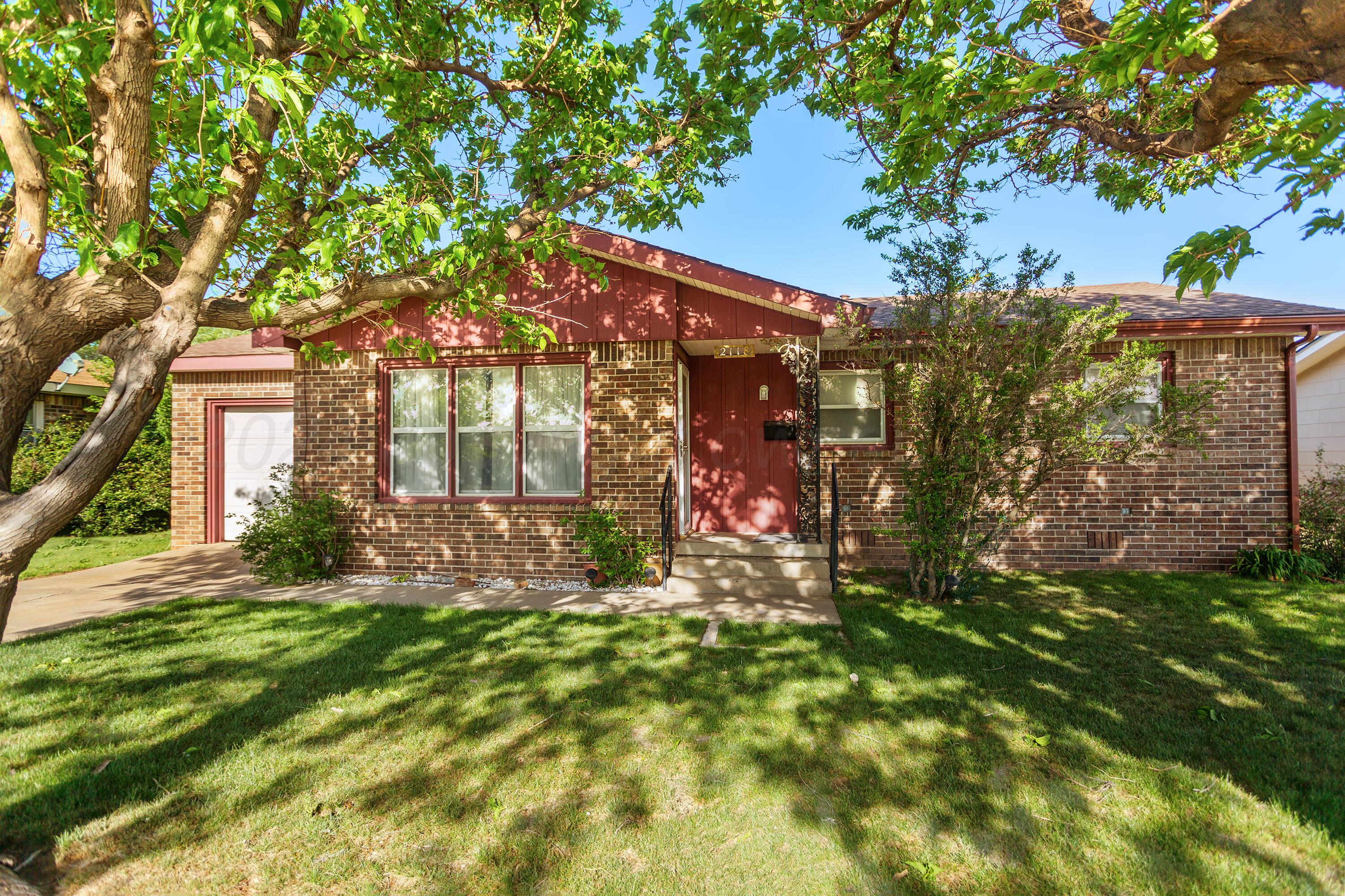 a view of a house with a tree in a yard