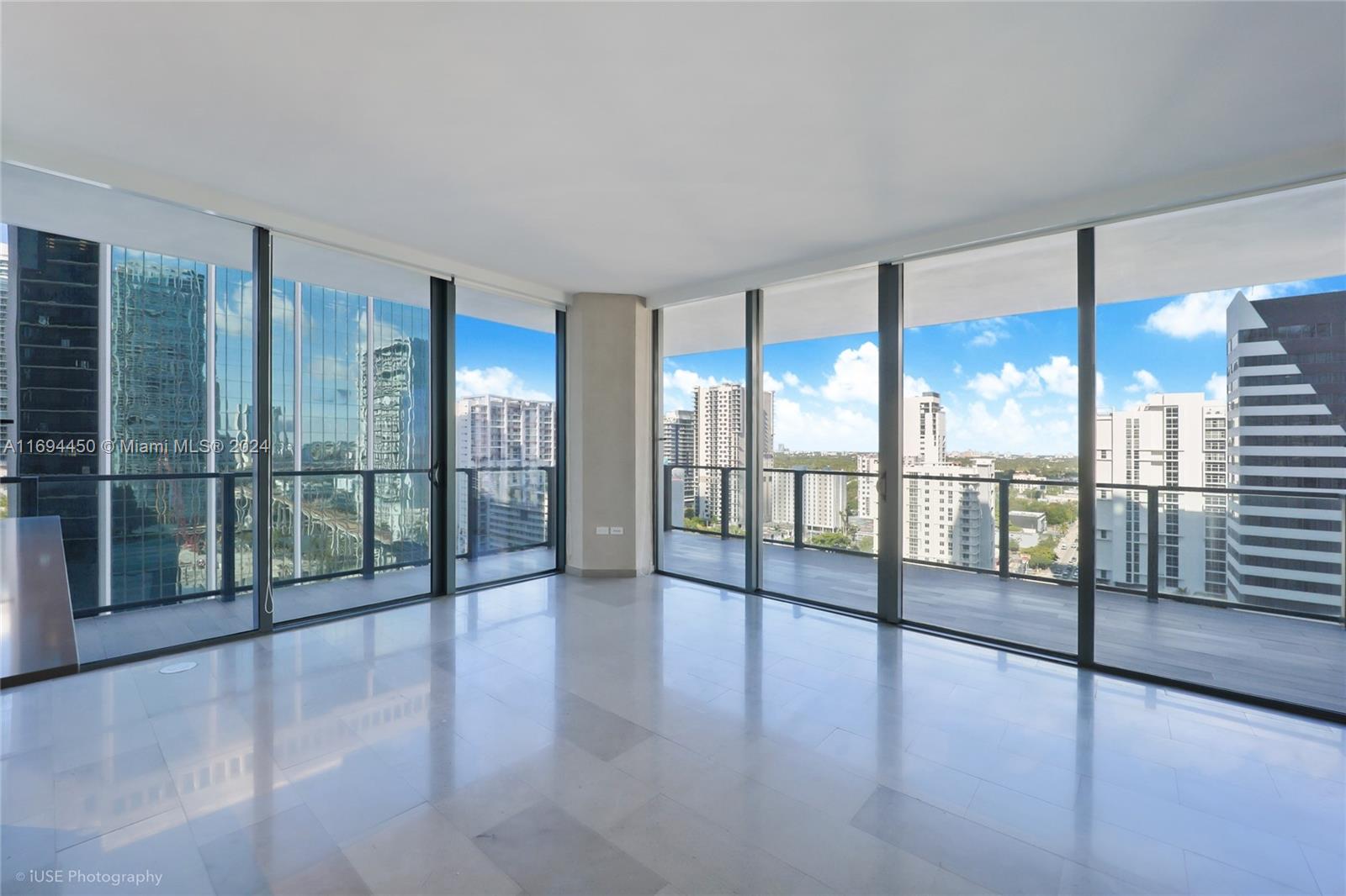 a view of an entryway with floor to ceiling windows