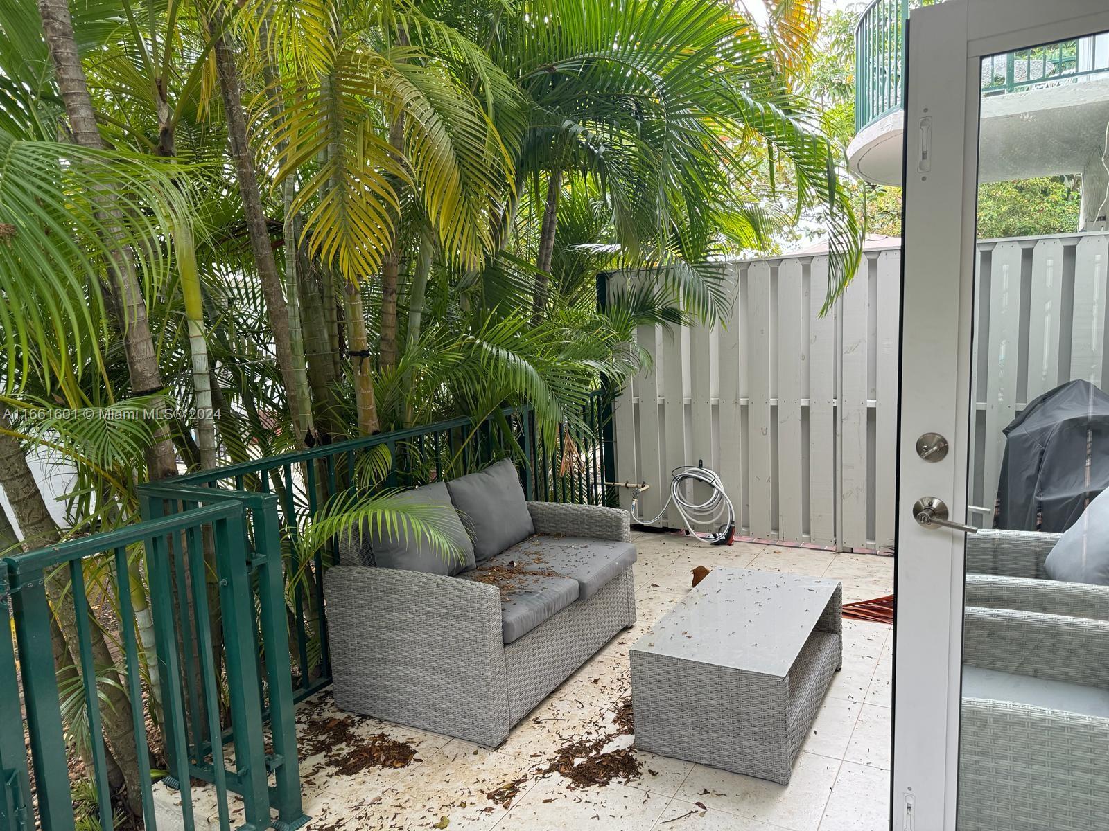 a outdoor space with patio couches and a potted plant