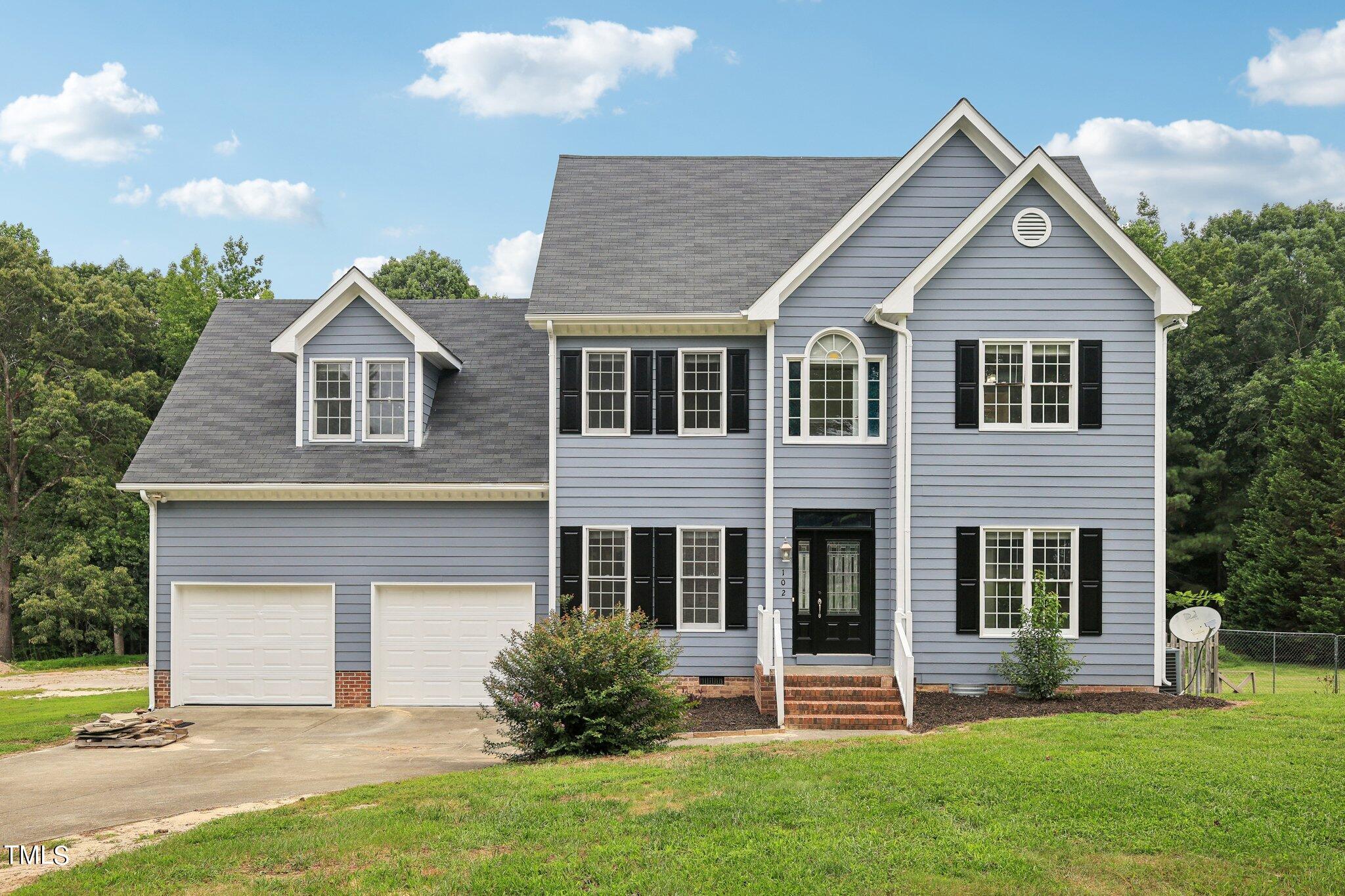 front view of a house with a yard