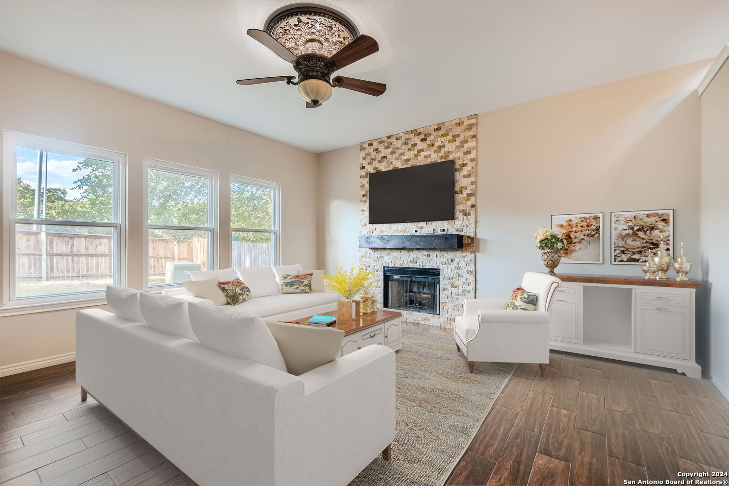 a living room with furniture a fireplace and a flat screen tv