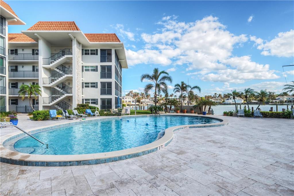 View of swimming pool featuring a patio and a water view