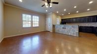 a view of a livingroom with furniture wooden floor and a window