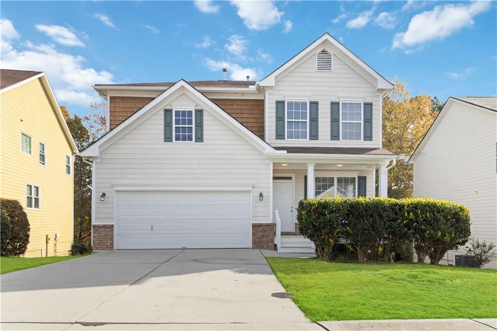 a front view of a house with a yard