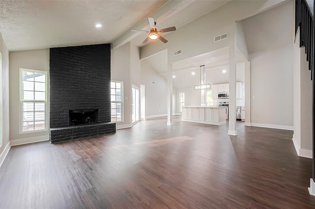 Living room has high ceilings and so much natural light