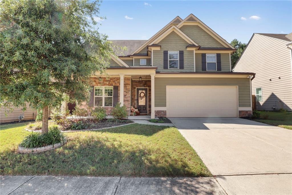 a front view of a house with a yard and garage