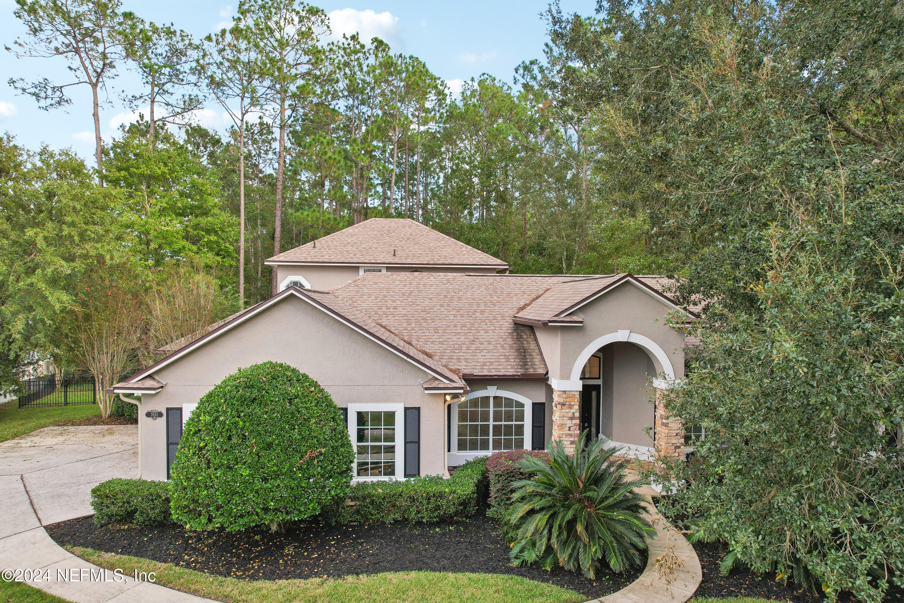 a front view of a house with garden