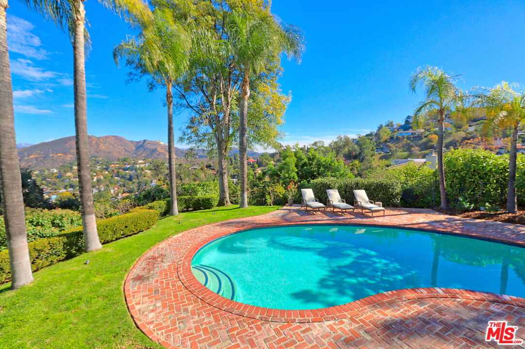 a view of a swimming pool with a yard