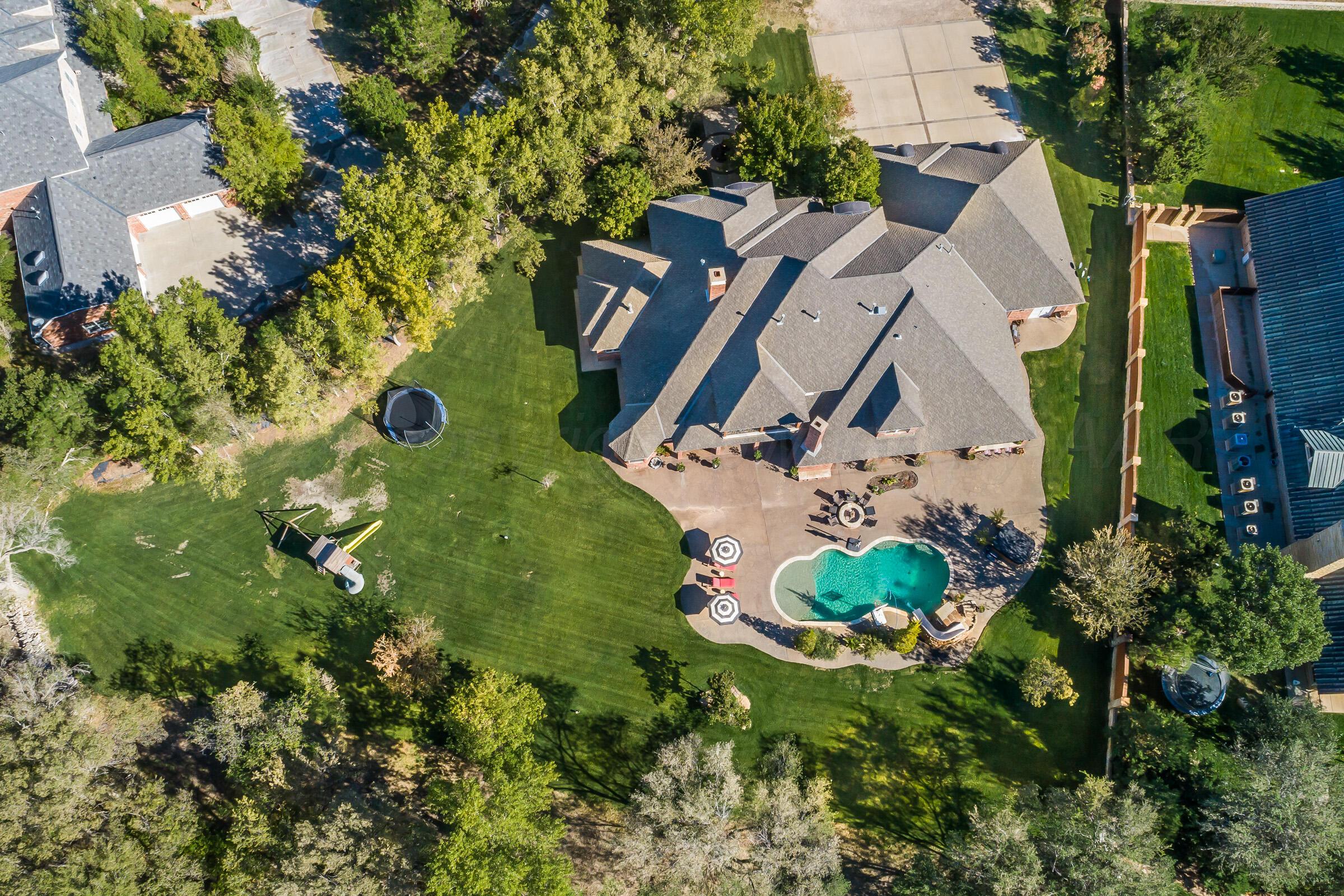 an aerial view of a house with a yard