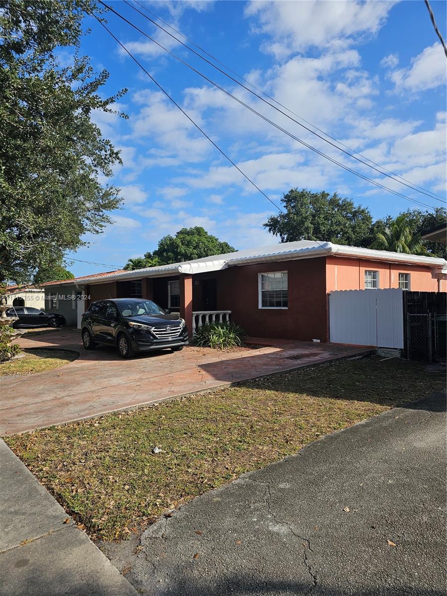 a front view of a house with yard and parking