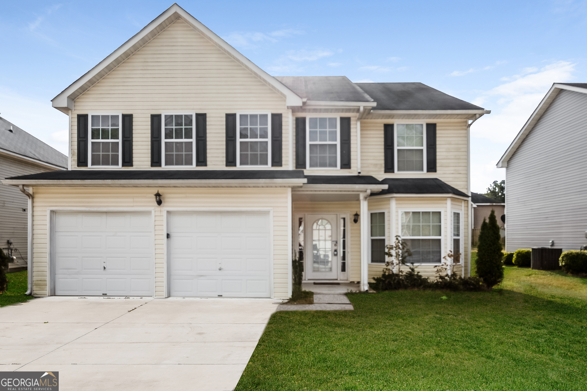 front view of a house with a yard