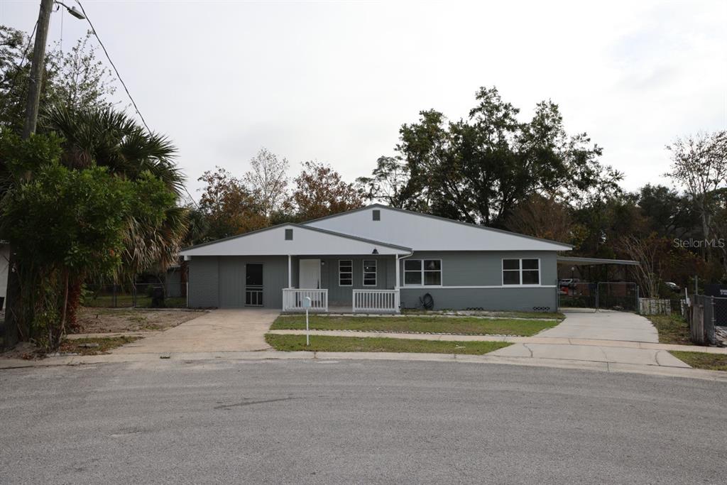 a front view of a house with a yard and trees