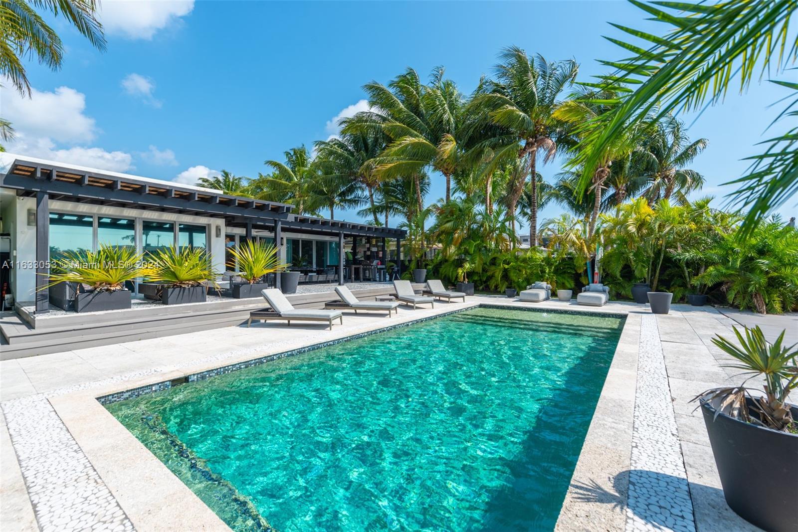 a swimming pool with outdoor seating and yard