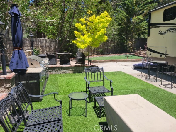 a view of yard with seating area and trees