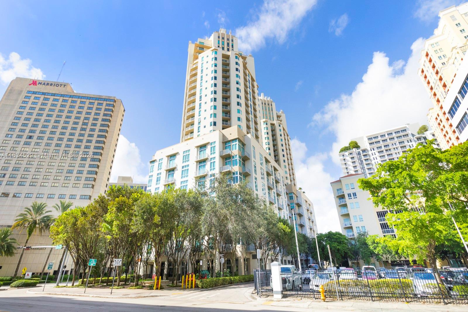 a view of a tall building next to a road