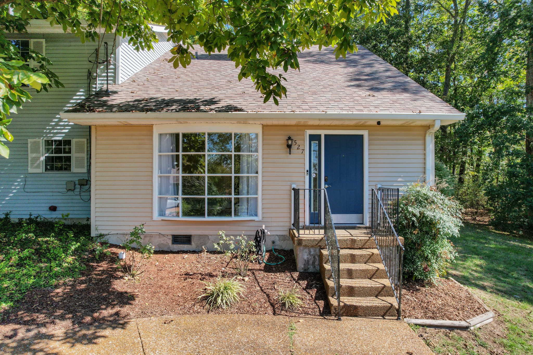 a front view of a house with a garden