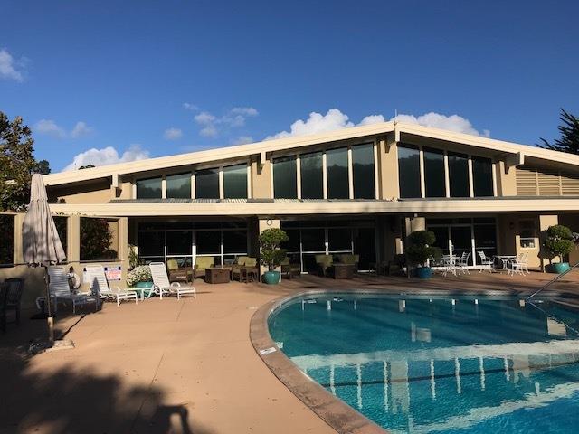 a front view of a building with sitting area