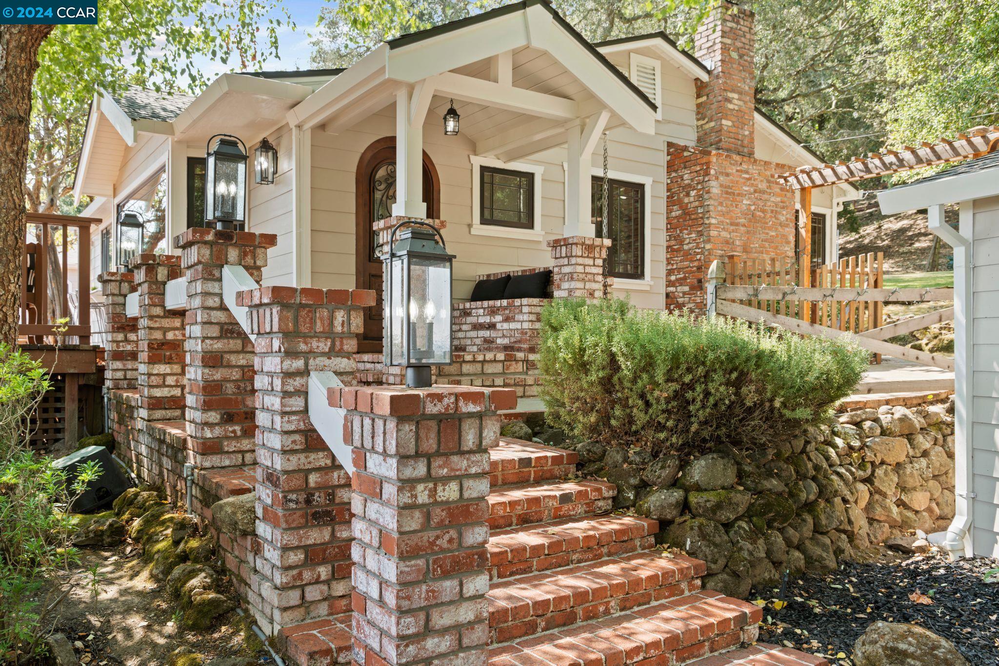 a front view of a house with outdoor seating