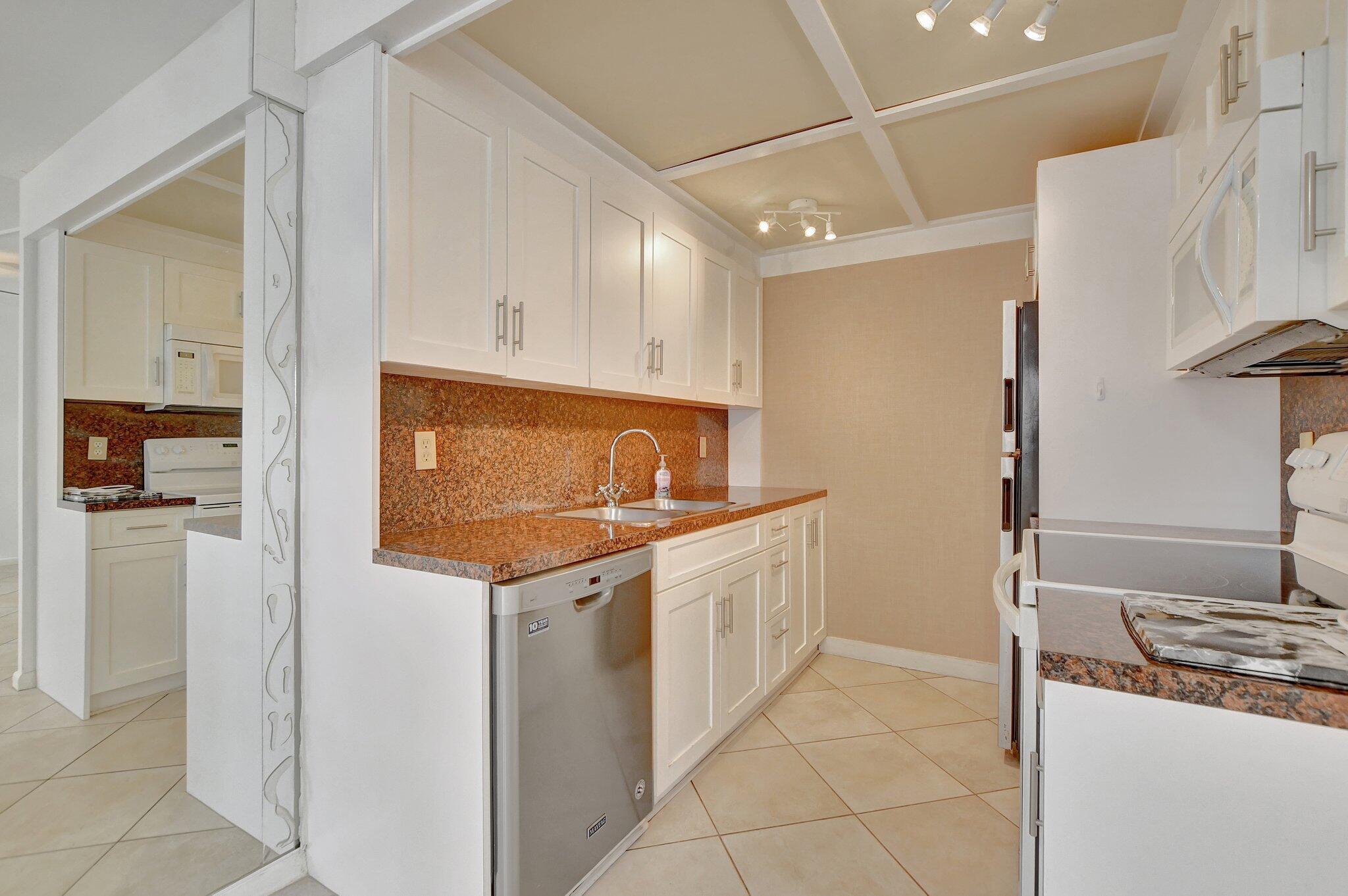 a kitchen with stainless steel appliances granite countertop a refrigerator and a stove