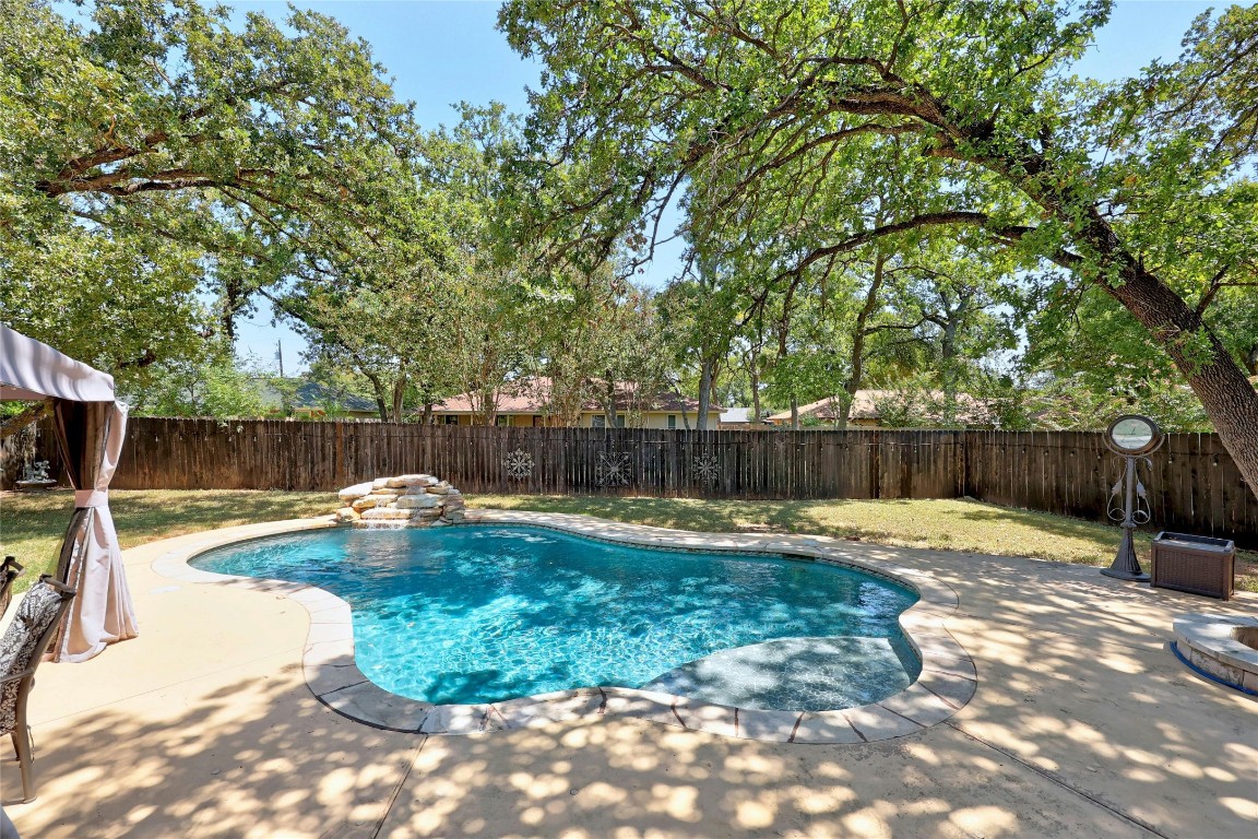 a view of a backyard with swimming pool