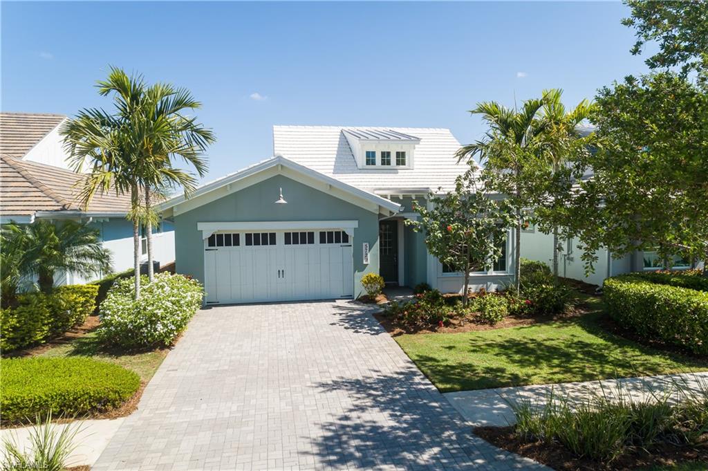 View of front of property with a garage and a front yard