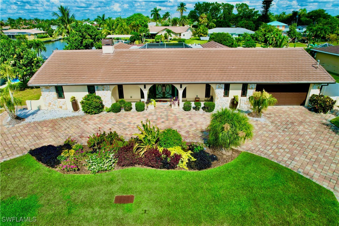 an aerial view of a house with yard and green space