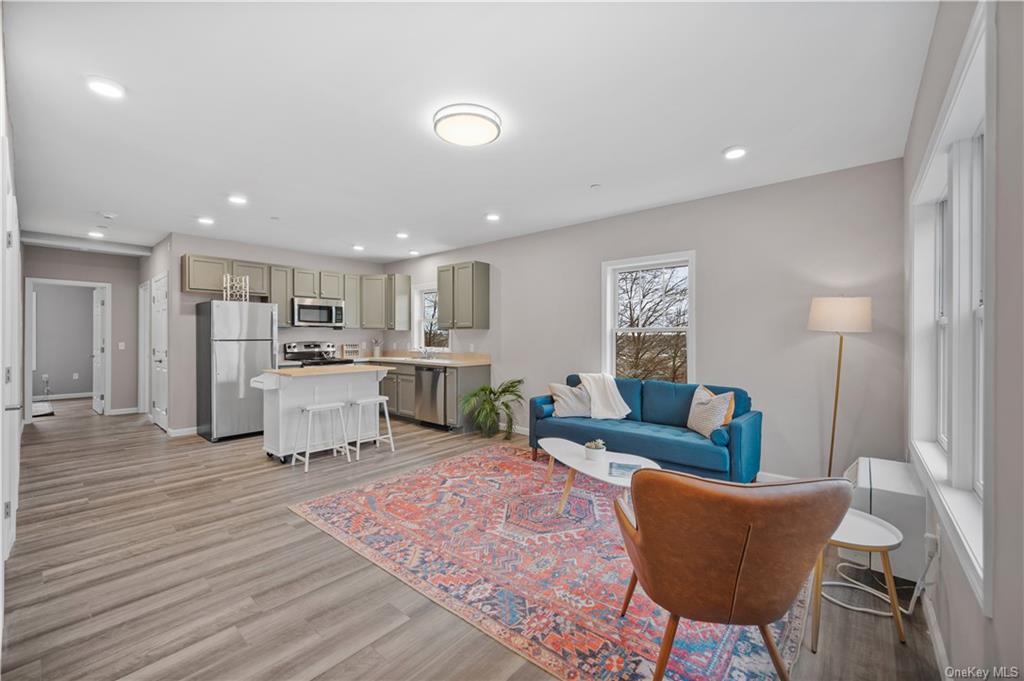 a living room with furniture and kitchen view