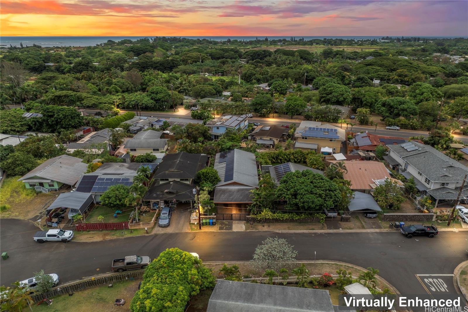 an aerial view of residential houses with outdoor space and street view