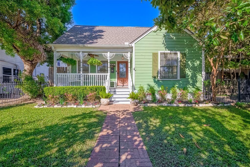 a front view of a house with a yard and porch