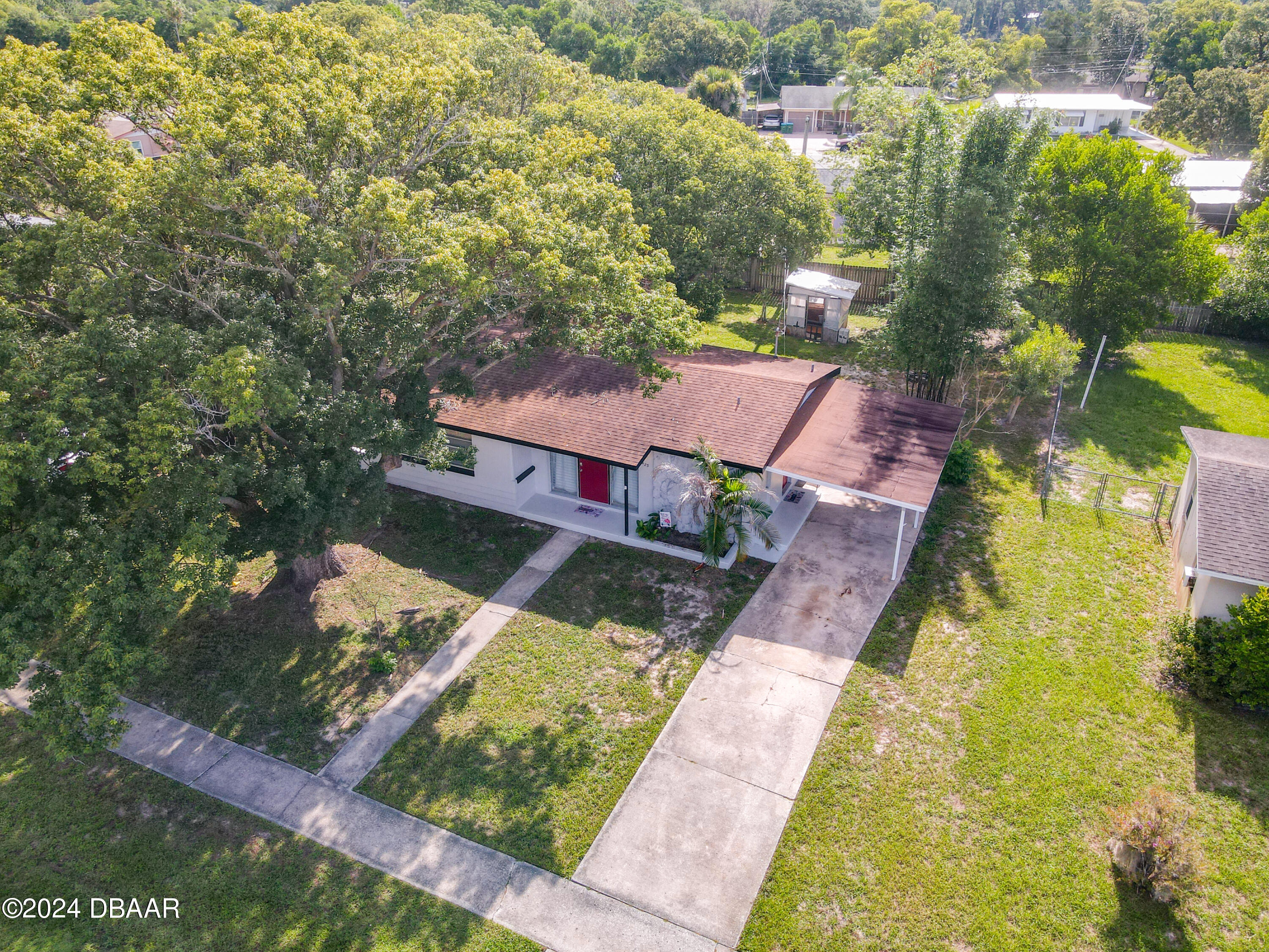 an aerial view of a house with a yard