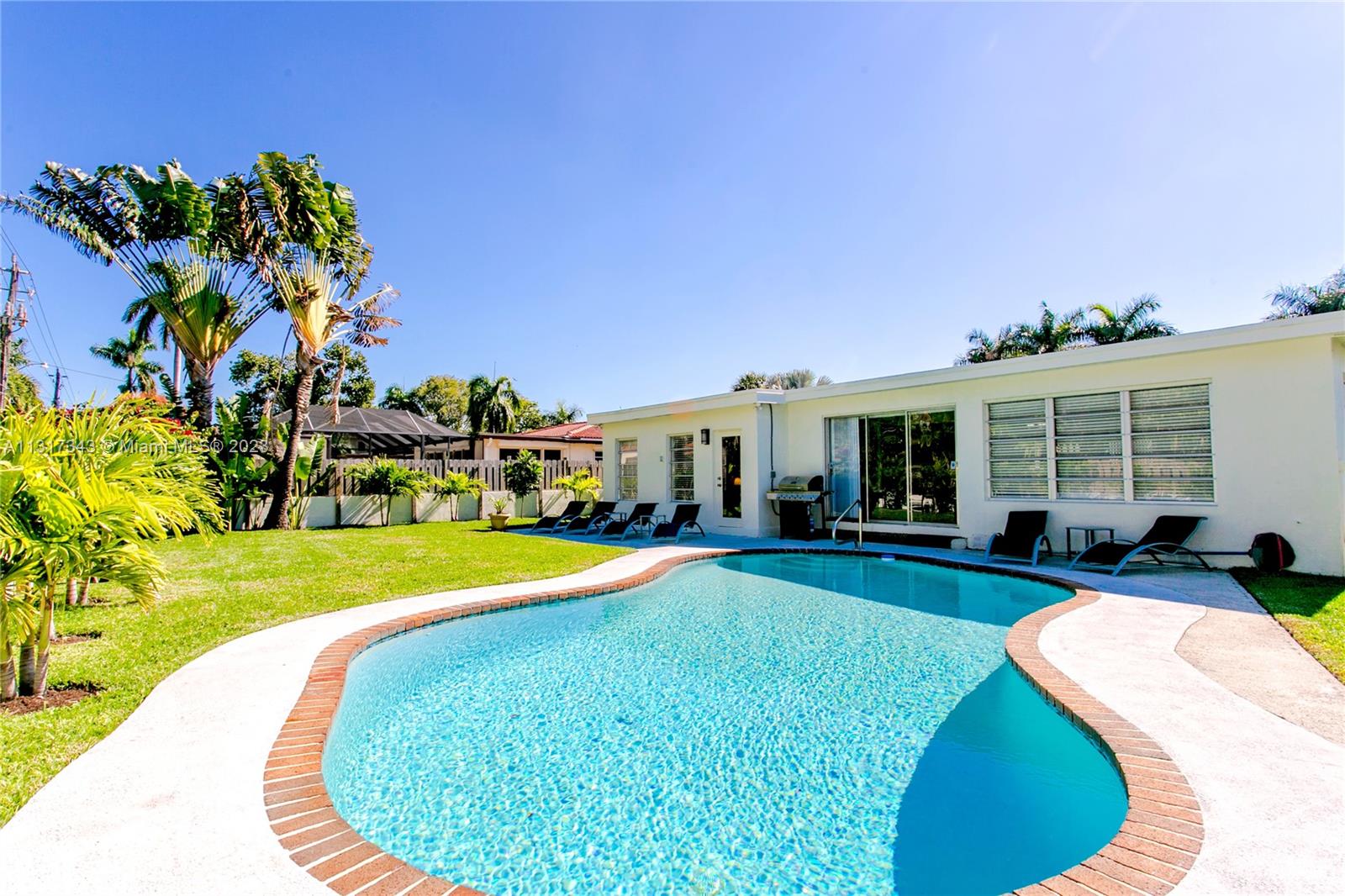 a view of a house with swimming pool and sitting area