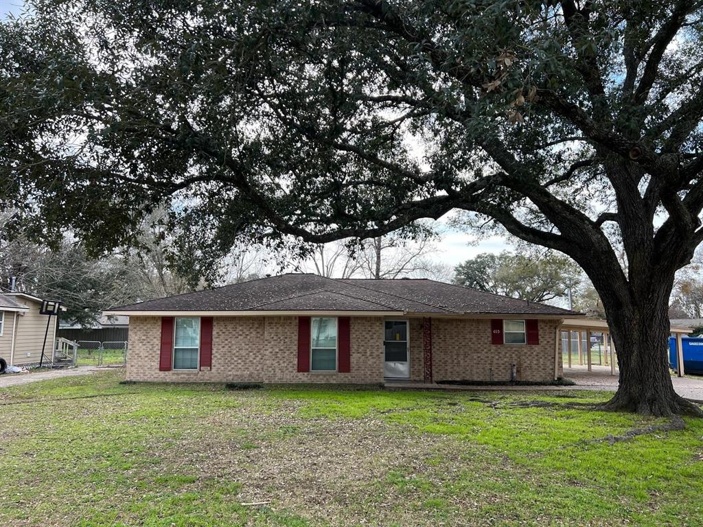 a house that has a tree in front of a house