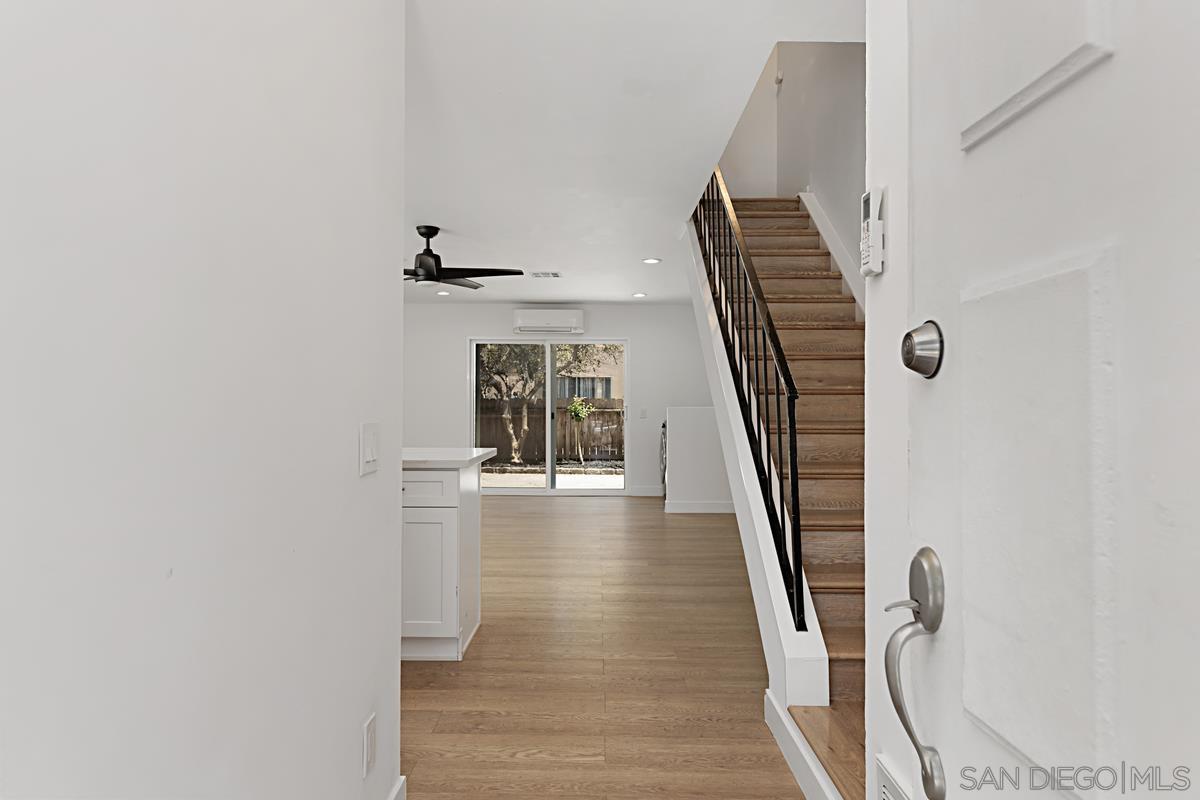 a view of entryway and hall with wooden floor