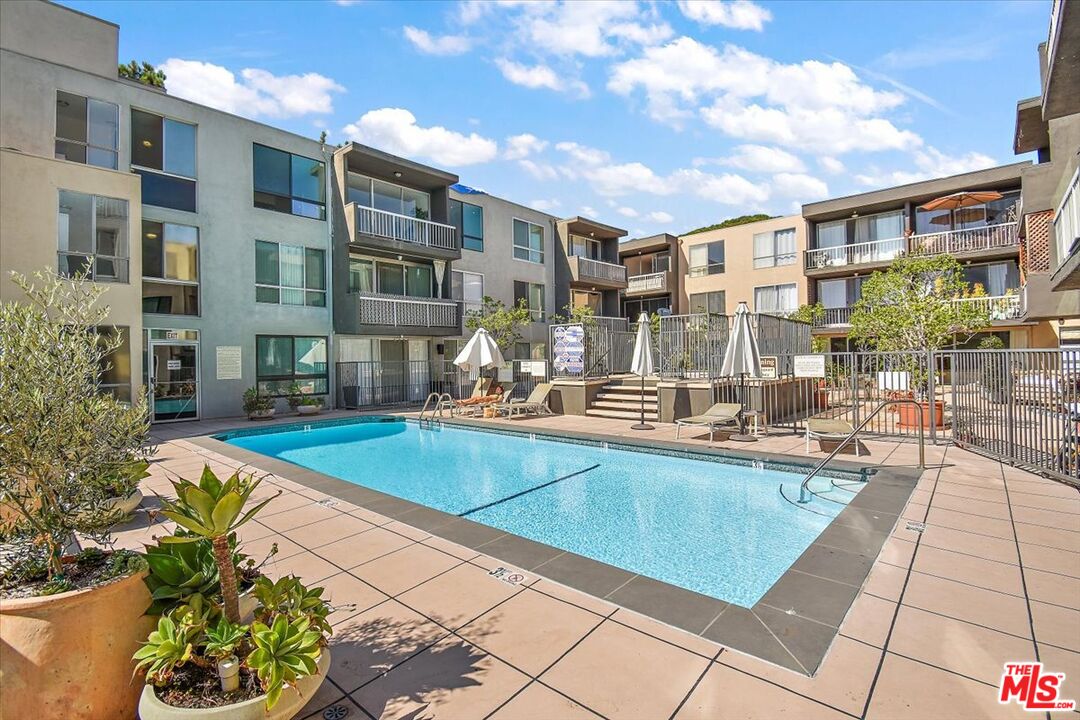 a view of a swimming pool with a lounge chairs