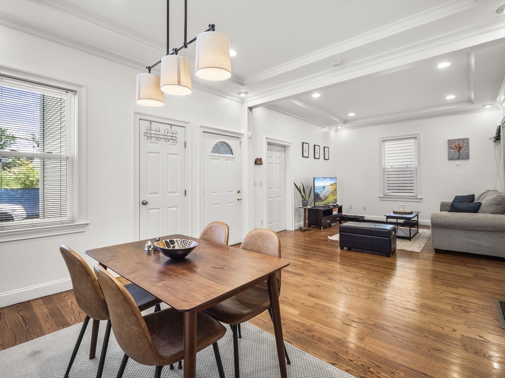 a living room with furniture kitchen view and a large window