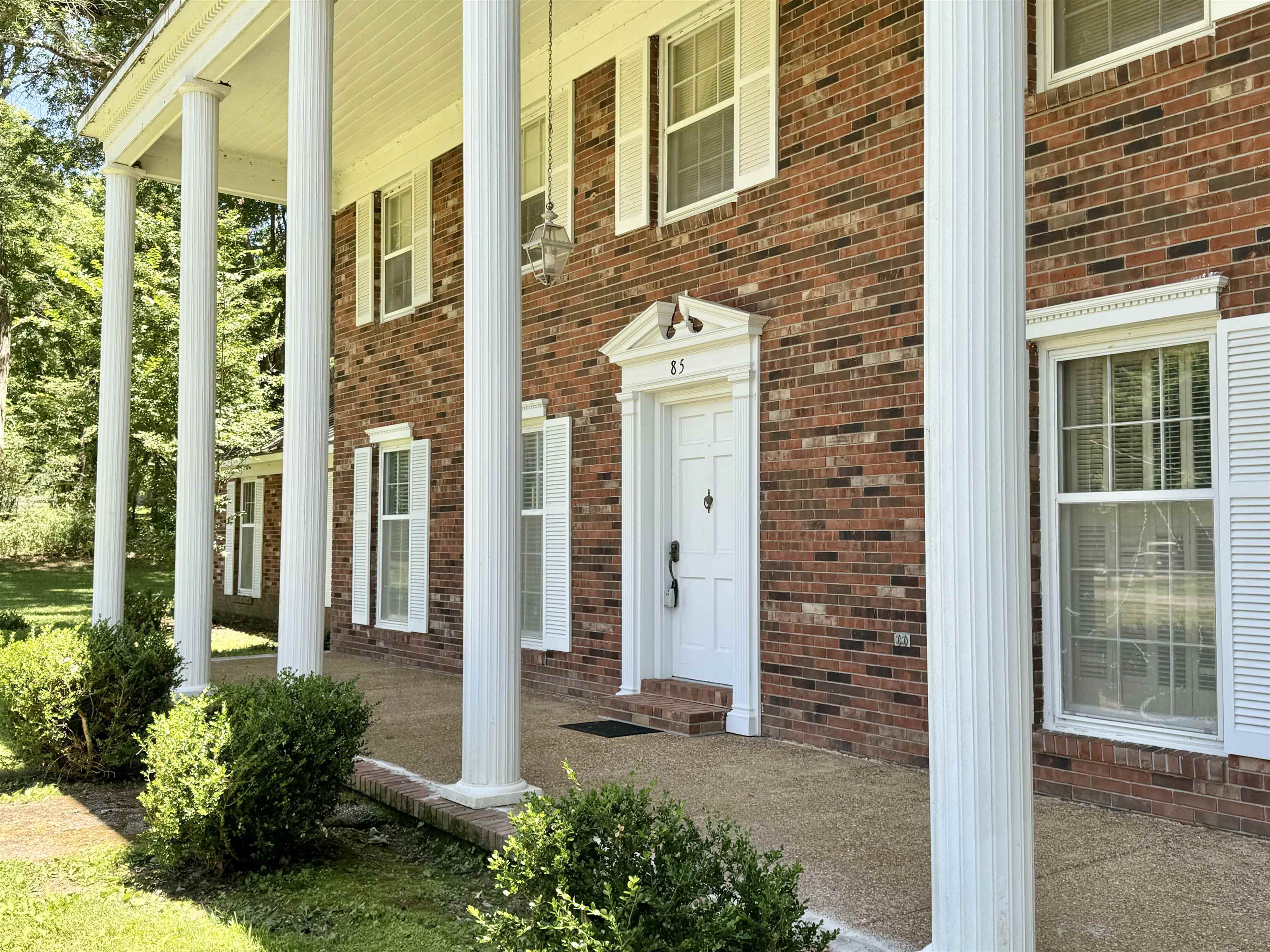 a view of a door with brick walls