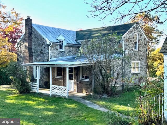 a view of a house with backyard porch and sitting area