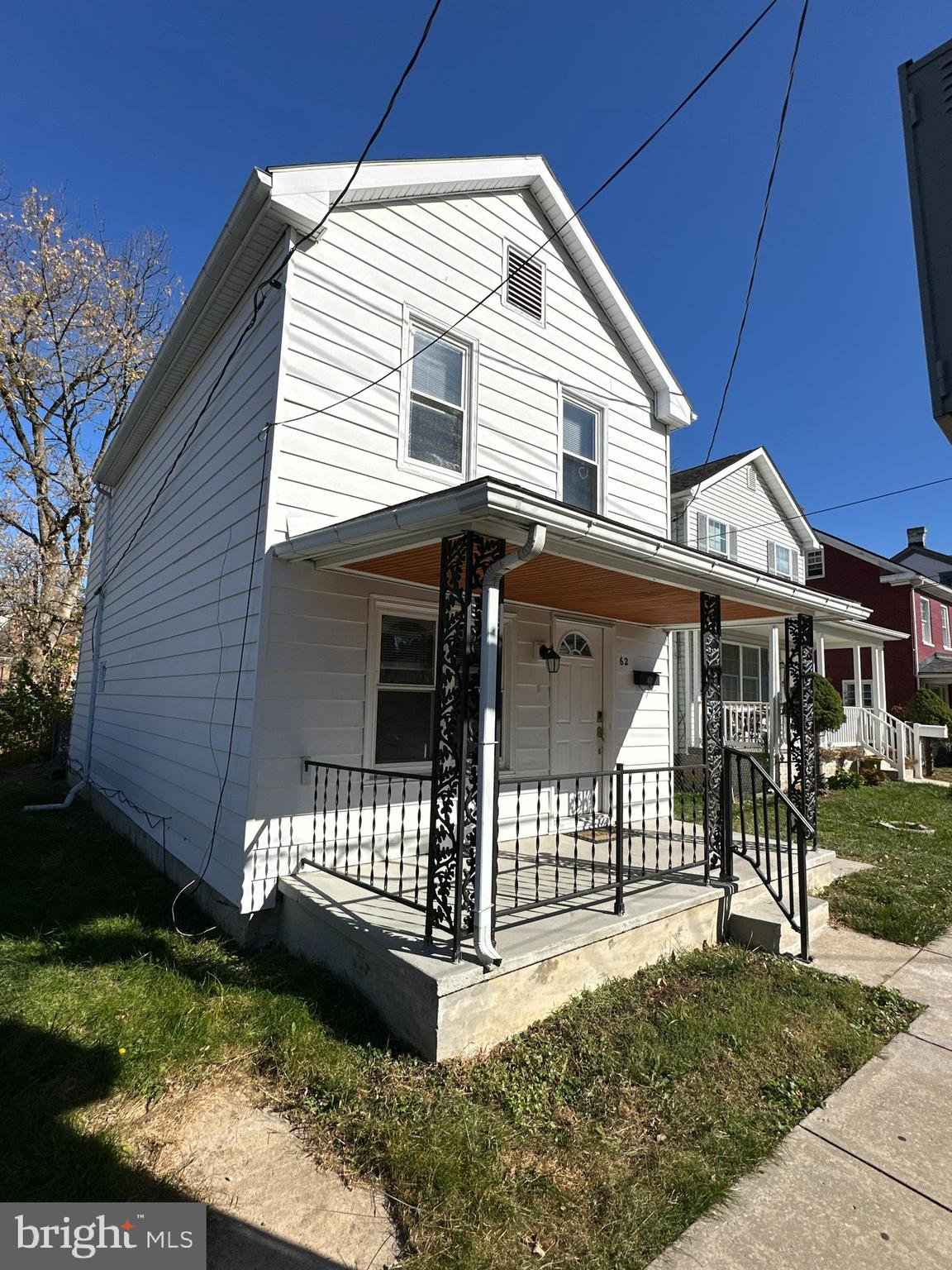 a view of a house with a yard and patio