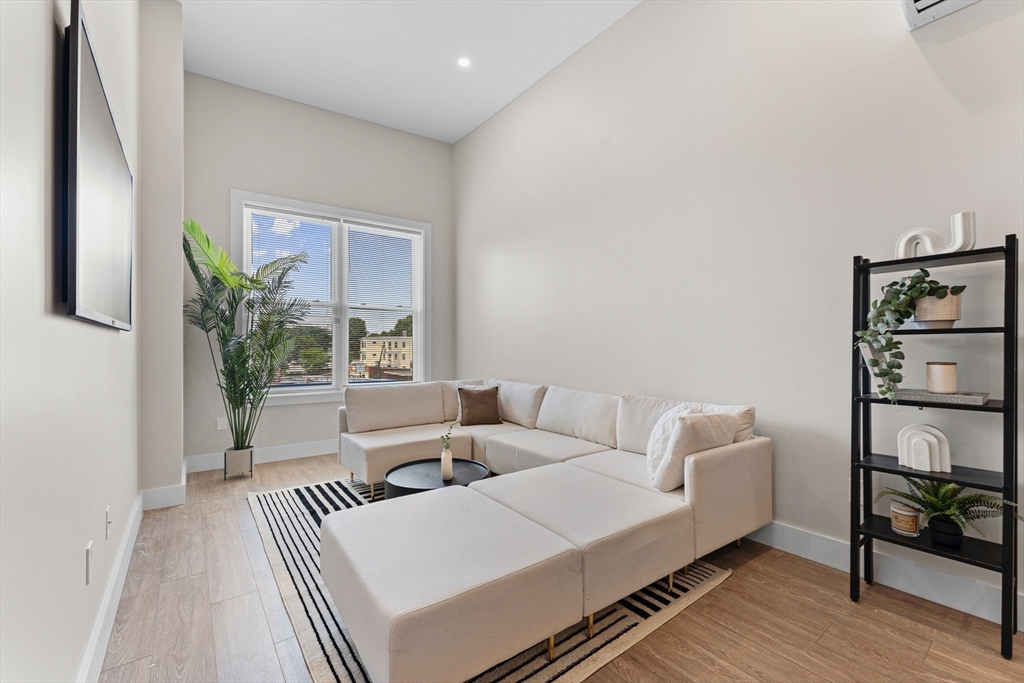 a living room with furniture and a potted plant