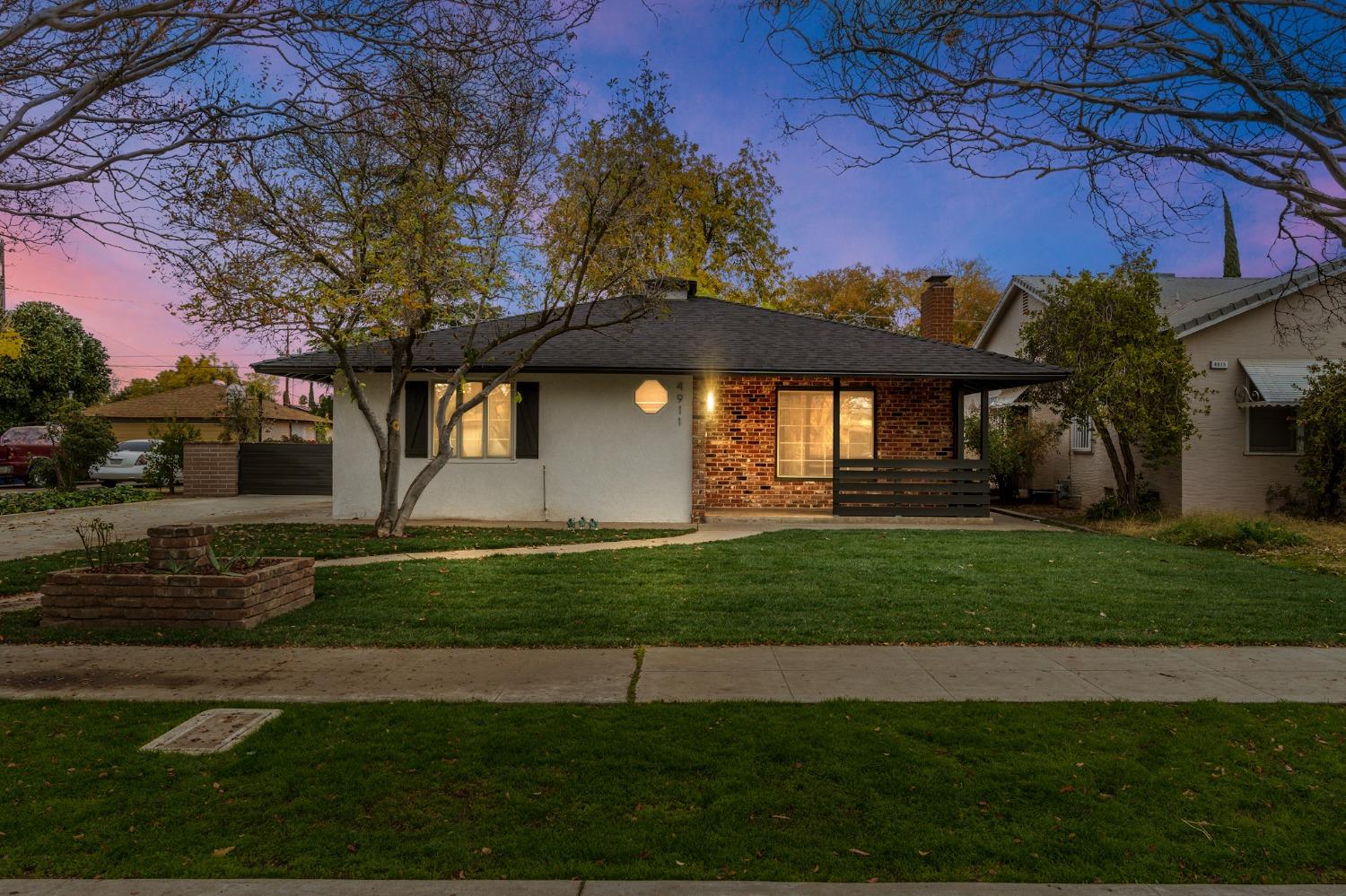 a front view of a house with a garden