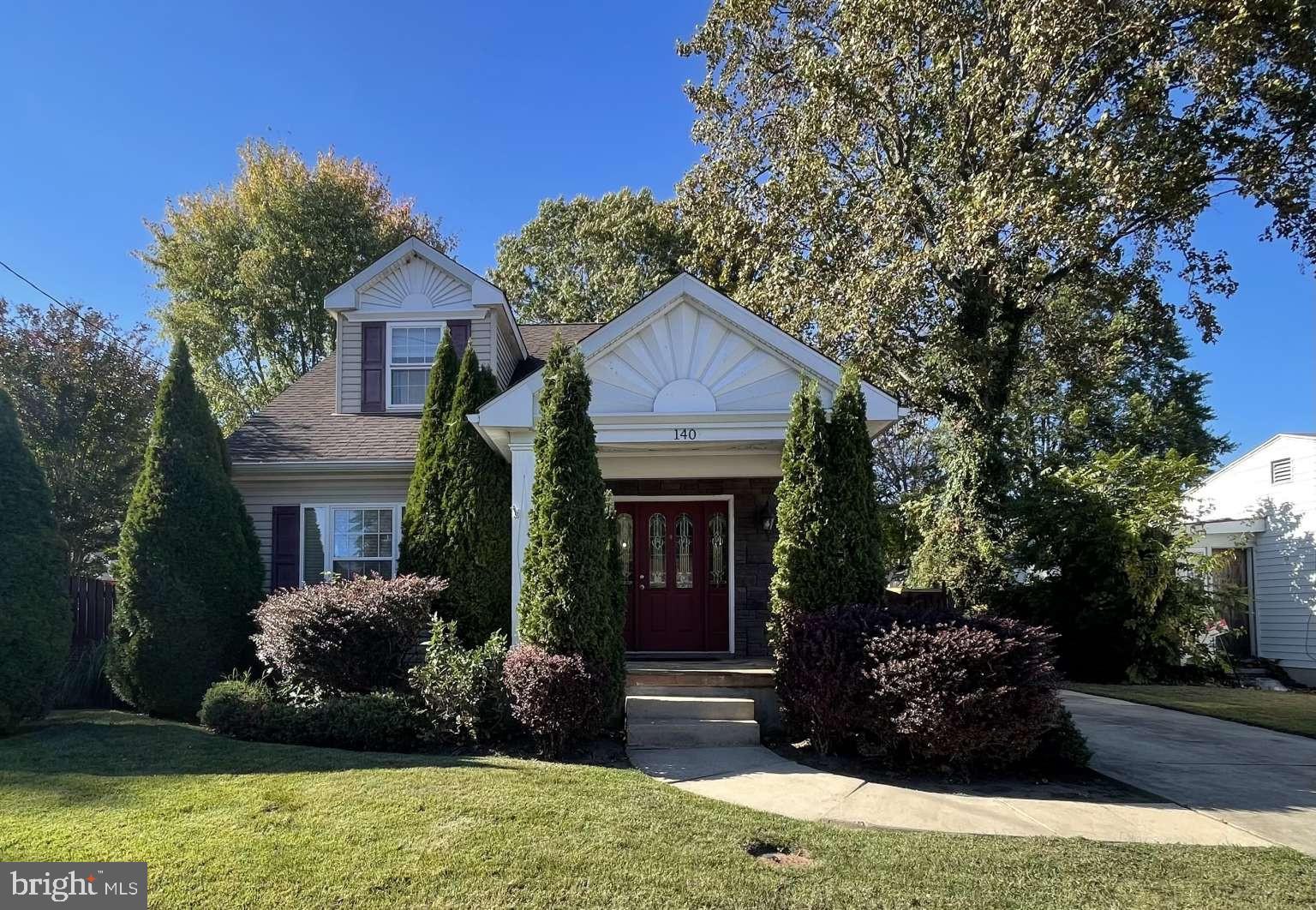 a front view of house with a garden