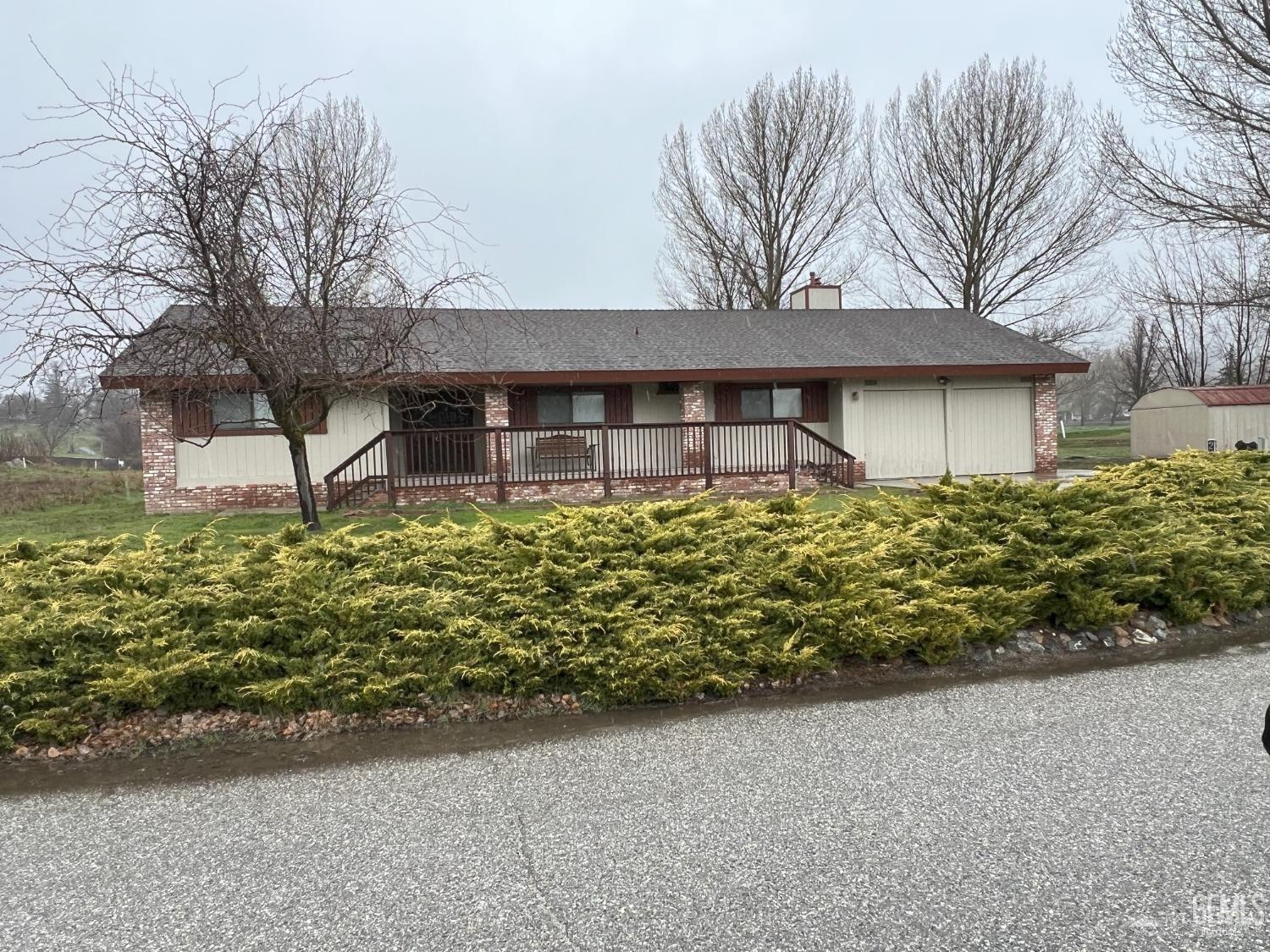 a house with lots of trees in the background