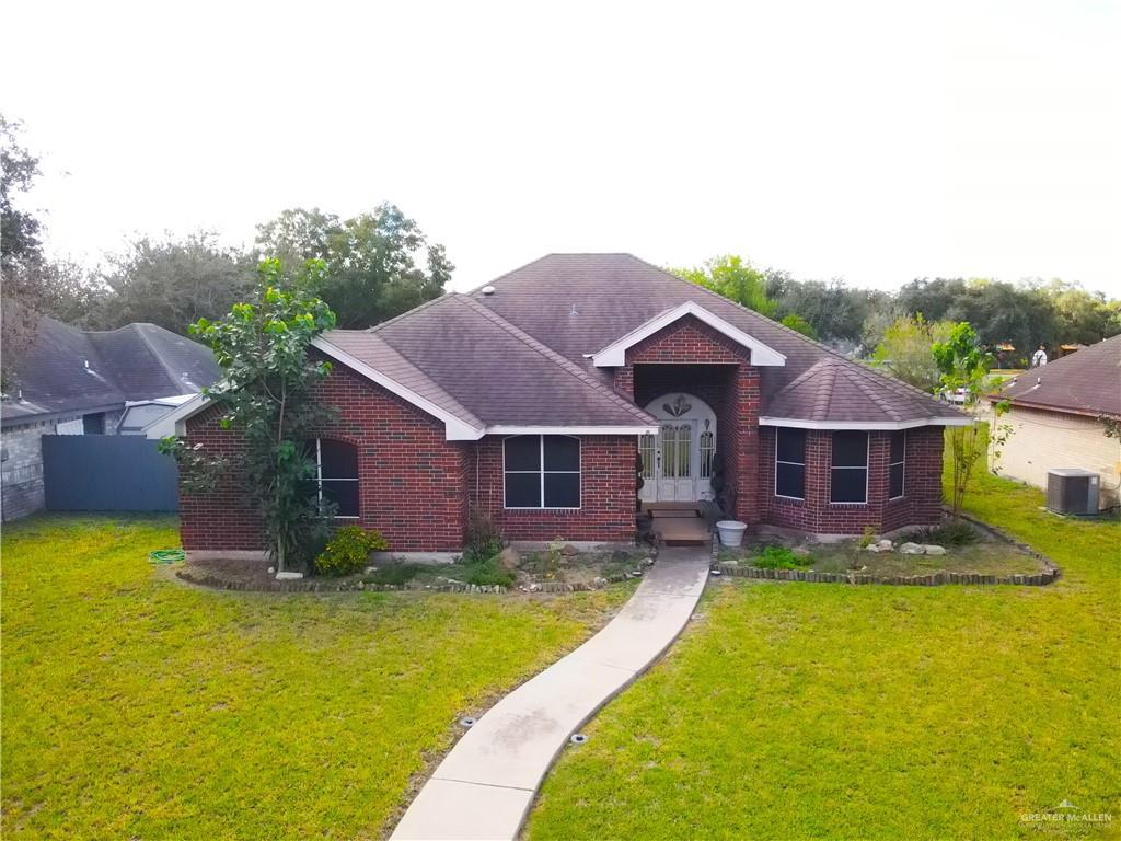 a view of a house with pool fire pit a large swimming pool and a yard