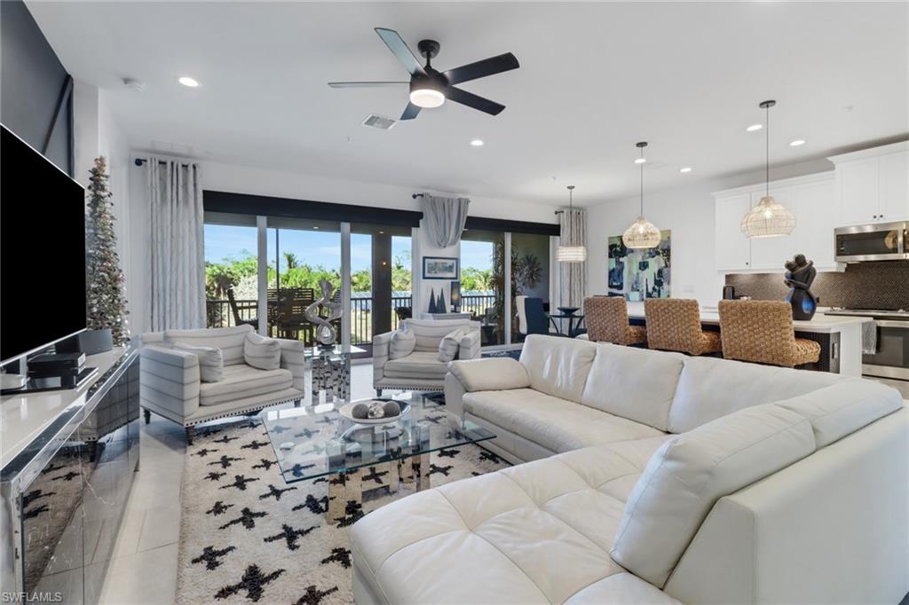 Tiled living room featuring ceiling fan