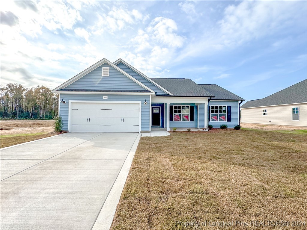 a front view of a house with a yard and garage