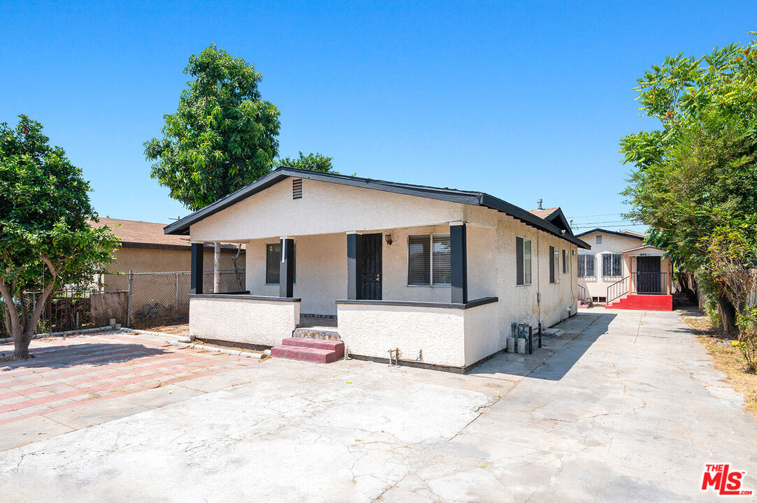 a front view of a house with a yard with furniture