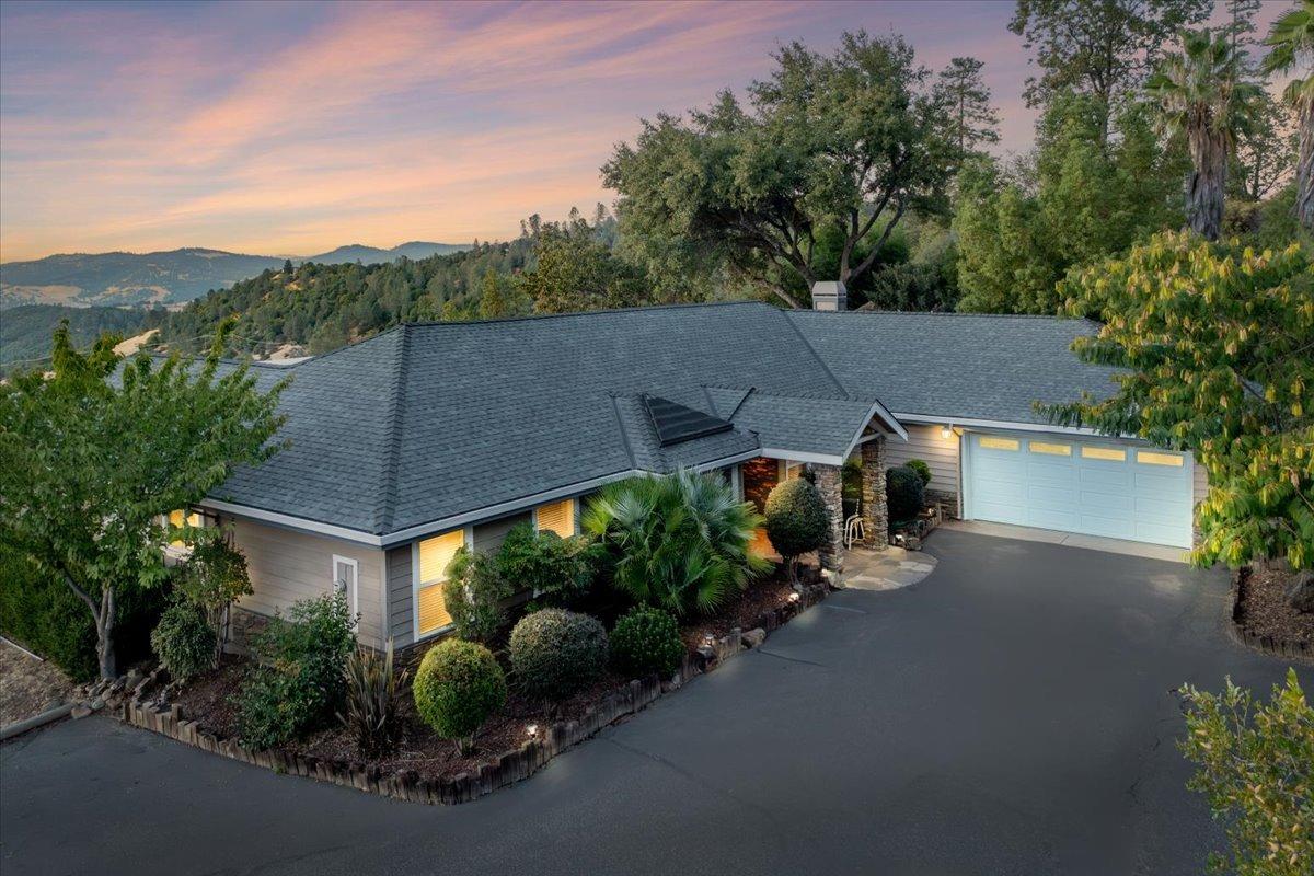 an aerial view of a house with porch and garden