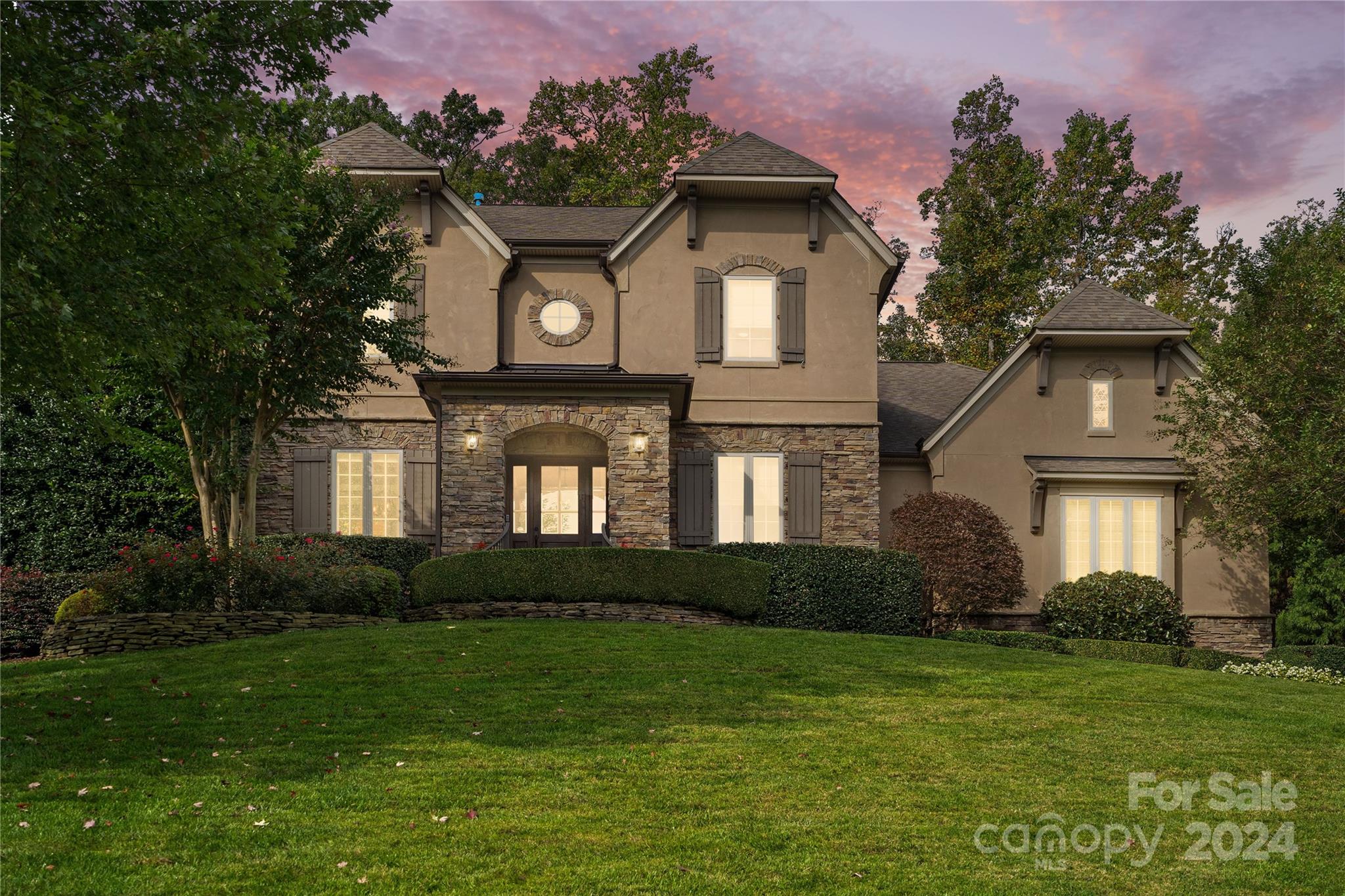 a front view of a house with a garden