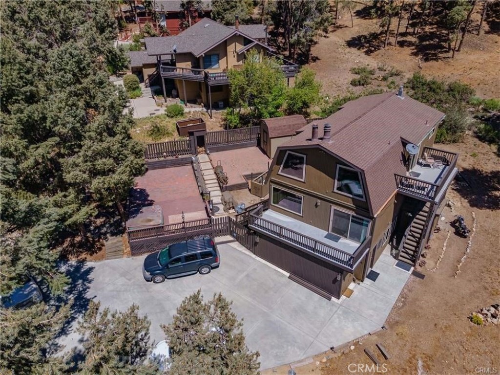 an aerial view of a house with swimming pool and outdoor seating